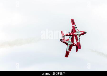 Two CT-114 Tutor aircraft of the Royal Canadian Air Force Snowbirds demonstration squadron perform a pass at 2019  Airshow London (Ontario, Canada). Stock Photo