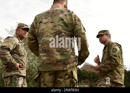 U.S. Army Maj. James Stanfield, right, and Sgt. 1st Class Horacio Morfin, left, both with the California Army National Guard’s 185th Military Police Battalion, 49th Military Police Brigade, meet with the battalion commander at the Randall Road Debris Basin, Jan. 13, 2023, in Montecito, California, while the 649th Engineer Company works to reroute the water flow as part of the state’s storm response. The basin is in the same area where a deadly mudflow hit in 2018. The engineers are supporting the Santa Barbara County Office of Emergency Management through the California Governor's Office of Em Stock Photo