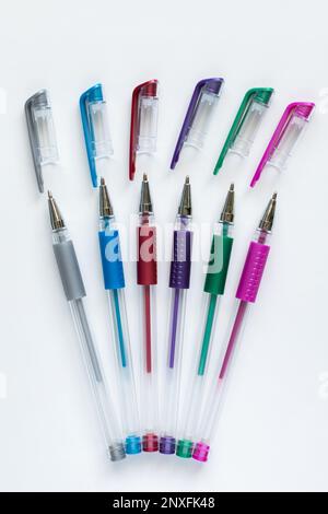 Set of colorful gel pens with open pen caps on white background. Stock Photo