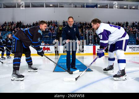 U.S. Air Force Academy -- Lt. Gen. John E Shaw Deputy Commander, U.S. Space Command performs the ceremonial puck drop for Air Force's Blake Bride and Niagara University's Ryan Cox before a hockey game at the Cadet Ice Arena on Jan. 21, 2023 in Colorado Springs, Colo. Air Force was defeated by Niagara 1-2. Stock Photo