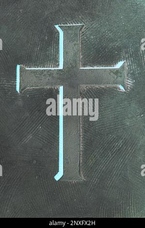 A simple typical cross embossed on a copper metal wall Stock Photo - Alamy