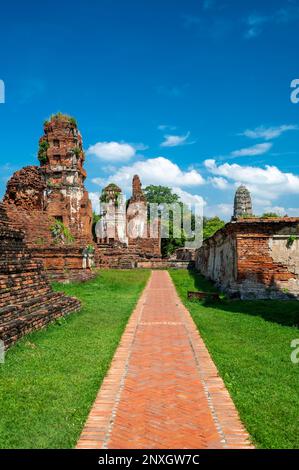 Ruins of ancient city and temples Ayutthaya, Thailand. Old kingdom of Siam. Summer day with blue sky. Famous tourist destination, spiritual place near Stock Photo