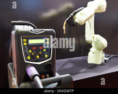 Modern welding machine inverter and robot manipulator Stock Photo