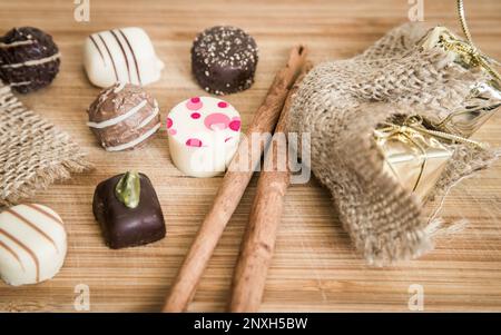 Chocolate pralines in a table setup. Praline present arranged on table. Candies and chocolates table decoration. Stock Photo