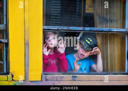 Children looking through the window. The Yellow Train or Train Jaune, Pyrénées-Orientales, Languedoc-Roussillon, France.  The Ligne de Cerdagne, usual Stock Photo