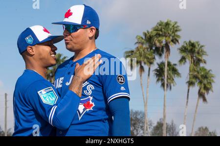 Toronto Blue Jays pitchers Marcus Stroman, right, and Pat Venditte trade  gloves in the first official workout of spring training in Dunedin, Fla.,  on Monday February 22, 2016. Venditte, who is ambidextrous