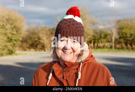 Woman smiling wearing a Christmas novelty hat Stock Photo