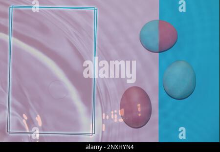 pink-blue eggs on the border pink-blue background, next to eggs is frame as copy space, underwater creative holiday background Stock Photo