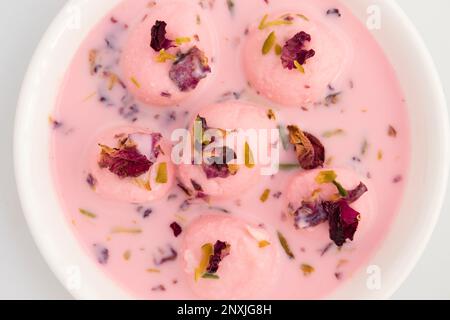 Lachhedar Pink Rose Rabdi Also Called Lachha Gulab Rabri, Gulabi Rabidi Made From Condensed Milk, Pearl Millet Flour, Dried Rose Petal, Gulab Jal Wate Stock Photo