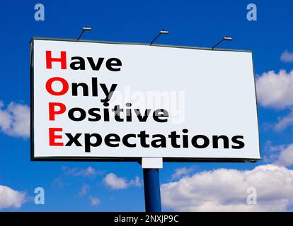 HOPE have only positive expectations symbol. Concept words HOPE have only positive expectations on big billboard against beautiful blue sky. Business Stock Photo