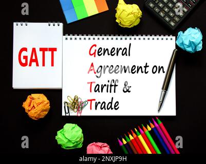 GATT symbol. Concept words GATT general agreement on tariff and trade on white note on beautiful black background. Business GATT general agreement on Stock Photo