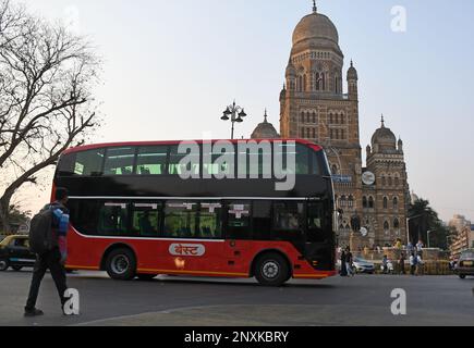 An airconditioned electric double decker bus drives by Brihanmumbai Municipal Corporation (BMC) building in Mumbai. The bus ferries office-goers on the route from Chhatrapati Shivaji Maharaj Terminus (CSMT) to Nariman Point. Stock Photo