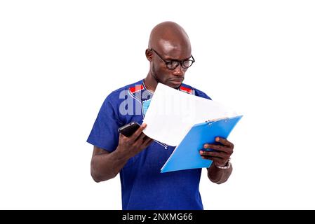 portrait of a serious businessman wearing glasses, checking contract on clipboard. Stock Photo