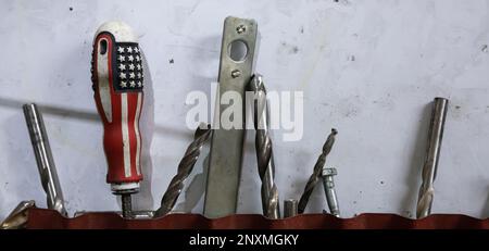 tools in the workshop drills, screwdrivers, scissors on the metal Stock Photo