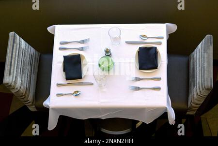 Aerial view of a table setting for two people in a restaurant. No people. Stock Photo