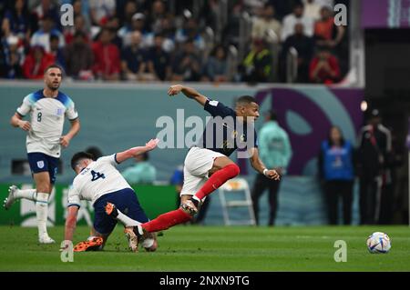 Kylian Mbappé (France) wins a footrace again England's Declan Rice during their quarter-final bout in Qatar as Jordan Henderson (ENG) looks on. Stock Photo