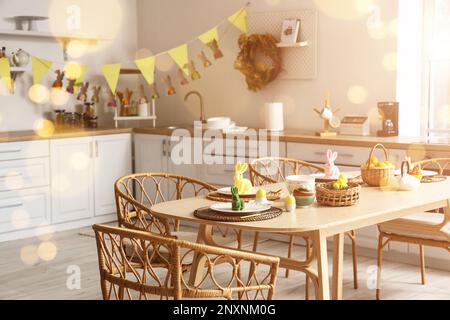 Festive table setting for Easter dinner in kitchen Stock Photo