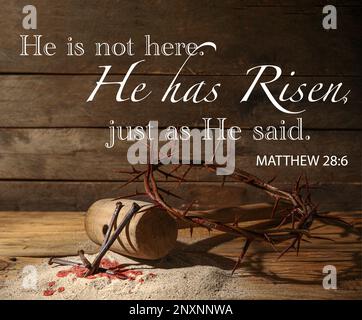 Text HE IS NOT HERE. HE IS RISEN, JUST AS HE SAID with crown of thorns, mallet and nails on wooden background Stock Photo