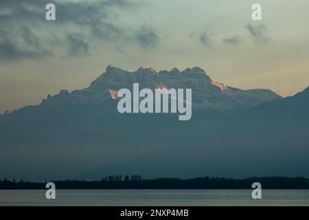 Sunset on jagged peaks of the Dents du Midi in the Chablais Alps canton of Valais Swiss Alps from Montreux on Lake Geneva Lac Leman Vaud Switzerland Stock Photo