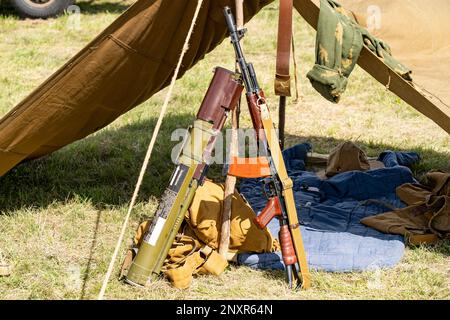 Military camp with Kalashnikov assault rifle and RPG-22 Anti-Tank rocket launcher Stock Photo