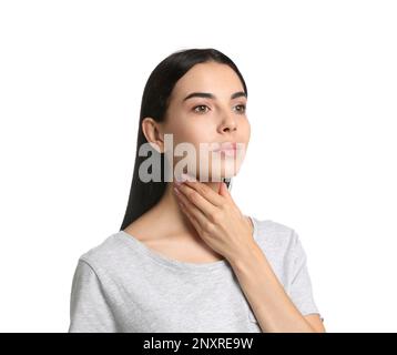 Young woman doing thyroid self examination on white background Stock Photo