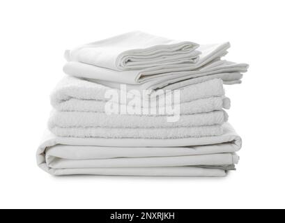 Stack of towels and bed sheets on white background Stock Photo