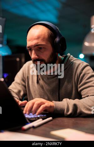 Database admin typing code and creating algorithm for it startup company, writing html script on multiple monitors. App developer working with temrinal window and programming source code. Stock Photo