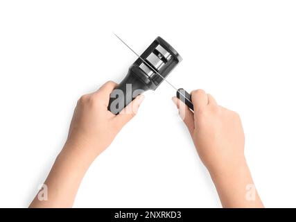 Woman sharpening knife on white background, top view Stock Photo