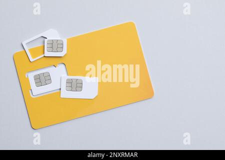Modern SIM cards on light grey background, flat lay Stock Photo