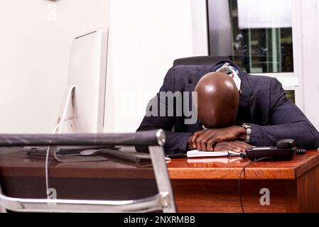 portrait of a tired adult businessman sleeping at the office. Stock Photo