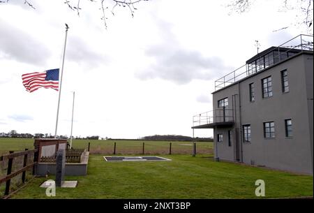 The Stars and Stripes flag flies at half staff at the 100th Bomb Group Memorial Museum, Thorpe Abbotts, England, Feb. 2, 2023, in honor of Staff Sgt. Al Arreola, World War II and 100th BG veteran, who passed away Feb. 1, 2023. Arreola was a 351st Bomb Squadron ball turret gunner based at Thorpe Abbotts during World War II and completed 35 missions during his time there. Airmen from today’s 351st Air Refueling Squadron performed a heritage patching ceremony at the former home of the 100th BG, and remembered the veteran and the legacy he and other World War II veterans have left behind. Stock Photo