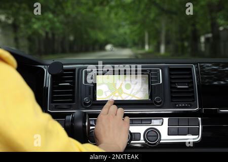 Woman using navigation system while driving car, closeup Stock Photo