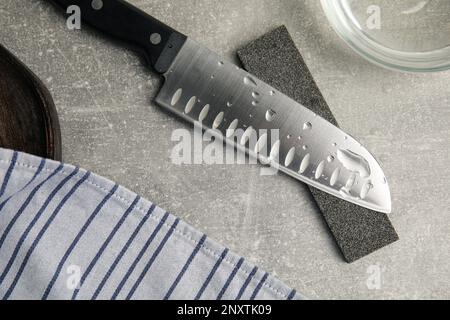 kitchen knife blade on grindstone Stock Photo - Alamy