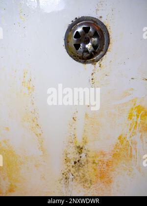 Plumbing. Mold in the bathroom. Black dots of mold and yellow plaque. Black mold Dirt on tiles ...