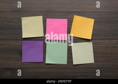 Blank colorful stickers on wooden table, flat lay Stock Photo
