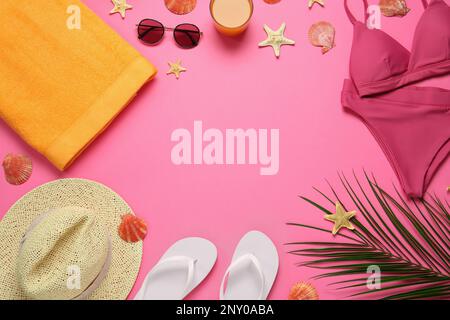Frame made with different beach objects on pink background, flat lay. Space for text Stock Photo