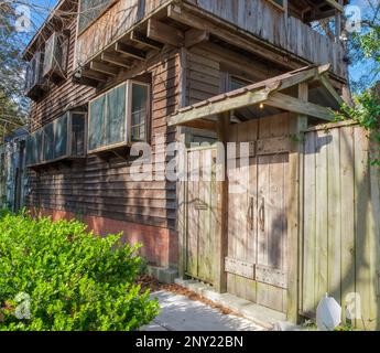 NEW ORLEANS, LA, USA - FEBRUARY 26, 2023: Angled side view of rustic wooden home with wooden fence and gate in Black Pearl Neighborhood Stock Photo