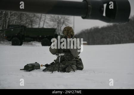 A Soldier from the 1-120th Field Artillery Regiment, Wisconsin Army National Guard, uses an aiming collimator during Northern Strike 23-1, Jan. 21, 2023, at Camp Grayling, Mich.The 120th FA is building readiness by conducting cold-weather training designed to meet objectives of the Department of Defense’s arctic strategy. Stock Photo