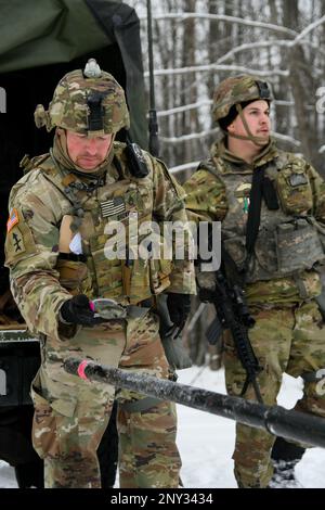 A Soldier from the 1-120th Field Artillery Regiment, Wisconsin Army National Guard, uses a compass to align a M119 howitzer during Northern Strike 23-1, Jan. 21, 2023, at Camp Grayling, Mich.The 120th FA is building readiness by conducting cold-weather training designed to meet objectives of the Department of Defense’s arctic strategy. Stock Photo