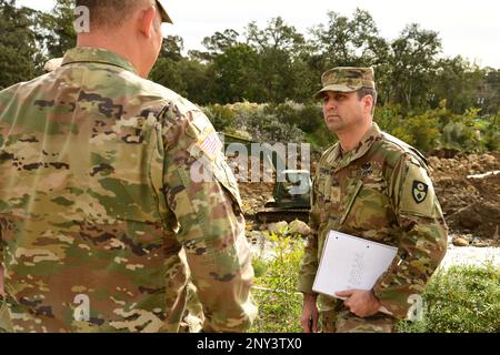 U.S. Army Maj. James Stanfield, right, executive officer of the California Army National Guard’s 185th Military Police Battalion, 49th Military Police Brigade, meets with Lt. Col. Donald Lipscomb, left, battalion commander, while the 649th Engineer Company works to reroute water flow inside the Randall Road Debris Basin as part of the state’s storm response, Jan. 13, 2023, in Montecito, California. The basin is in the same area where a deadly mudflow hit in 2018. The engineers are supporting the Santa Barbara County Office of Emergency Management through the California Governor's Office of Eme Stock Photo