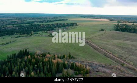 Calm picturesque landscape. Clip.Fields with tall colorful houses, grass and small residential buildings and roads. High quality 4k footage Stock Photo