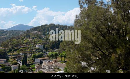 Green mountains with houses. Action.Summer sunny landscape on the mountains on which trees grow and where dwelling houses stand. High quality 4k foota Stock Photo