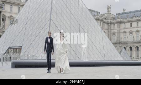 Wedding photography in tourist places. Action. A beautiful couple in smart suits walking around the square and posing for the camera. High quality 4k Stock Photo