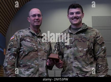 State Command Sgt. Maj. William Ferland of the New Hampshire Army National Guard, awards the Noncommissioned Officer of the Year Trophy to Staff Sgt. Davis Jollimore, a  training noncommissioned officer at the Recruit Sustainment Program, Recruiting and Retention Battalion, NHARNG, at the conclusion of the NHARNG Best Warrior Competition, Feb. 12, in Pembroke, N.H. Stock Photo