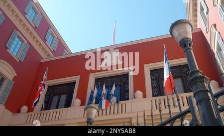 The government building in France. Action. A small red building decorated with flags against the blue sky from above. High quality 4k footage Stock Photo