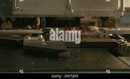 Close-up of automated drilling machine on wood. Creative. Automated machine for production of wood products processing. Drilling machine for holes in Stock Photo
