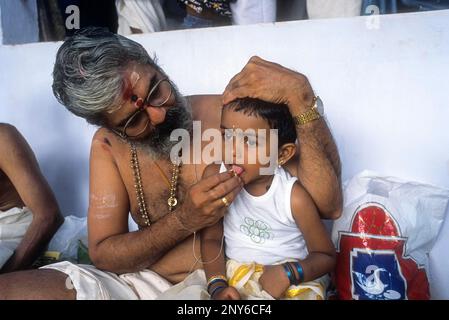 Ezhuthiniruthu Ceremony on Vijayadasami day in Saraswathy temple at Panachikadu near Kottayam, Kerala, India. Priest made to write a few alphabets on Stock Photo