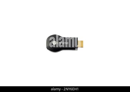 First generation Chromecast smart tv HDMI dongle isolated on white background. February 17, 2023: Swat, Pakistan. Stock Photo