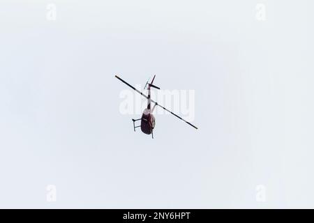 Helicopter in blue sky with Cirrus clouds Stock Photo