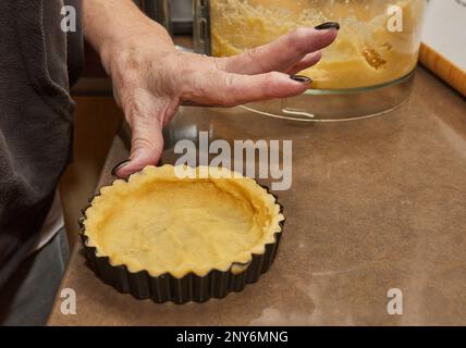 Process of making the base for Round Cream Pie with Chocolate and Strawberries. French recipe. Stock Photo